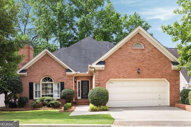 traditional home with brick siding, driveway, a garage, a front lawn, and a shingled roof