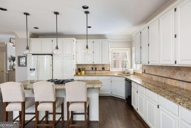 kitchen with white refrigerator with ice dispenser, dishwasher, a sink, white cabinetry, and crown molding