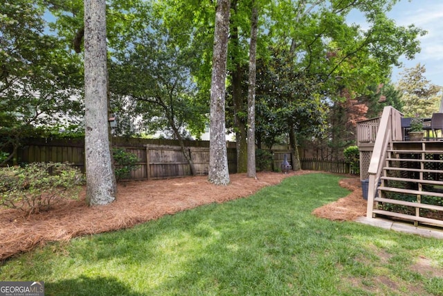 view of yard with a deck and stairway