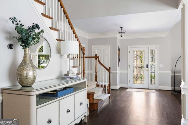 foyer featuring stairway, healthy amount of natural light, dark wood-type flooring, ornamental molding, and baseboards