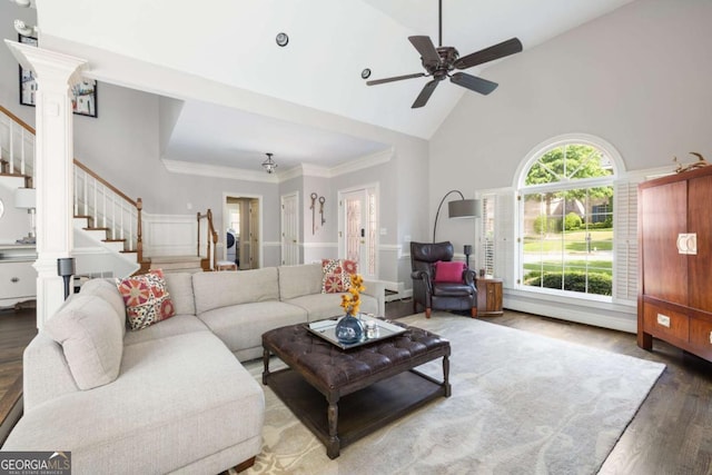 living area with high vaulted ceiling, stairway, wood finished floors, and ceiling fan