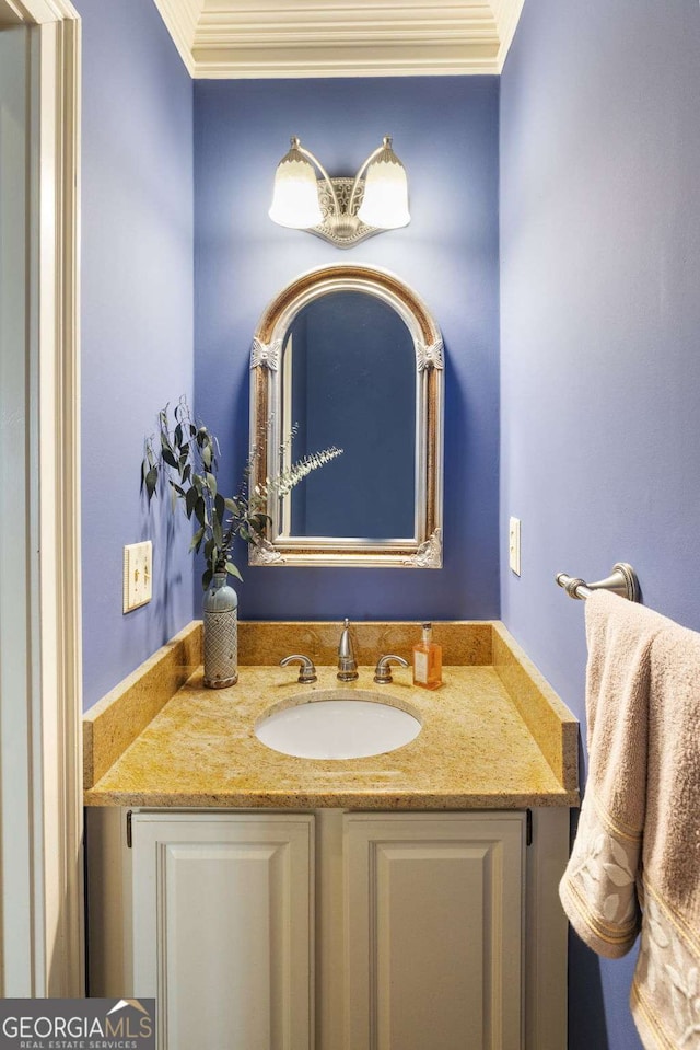 bathroom featuring ornamental molding and vanity