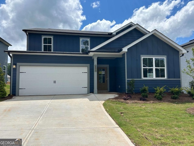 5221 Mulberry Crk Lot 44, Flowery Branch, GA 30542 - view of front of house featuring board and batten siding, driveway, a garage, and a front yard