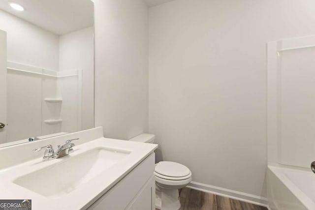 5221 Mulberry Crk Lot 44, Flowery Branch, GA 30542 - full bathroom featuring wood finished floors, toilet, vanity, baseboards, and recessed lighting