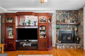 1822 Morgan Rd, Canton, GA 30115 - living area featuring wood finished floors and a fireplace