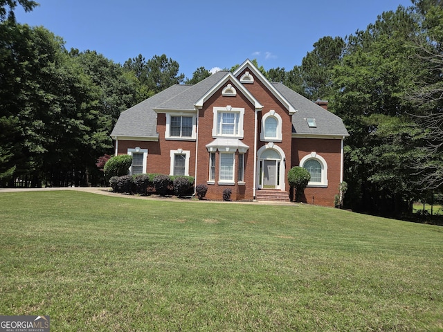 308 Bell Isle, Mcdonough, GA 30252 - view of front of property with a front lawn, brick siding, and a chimney