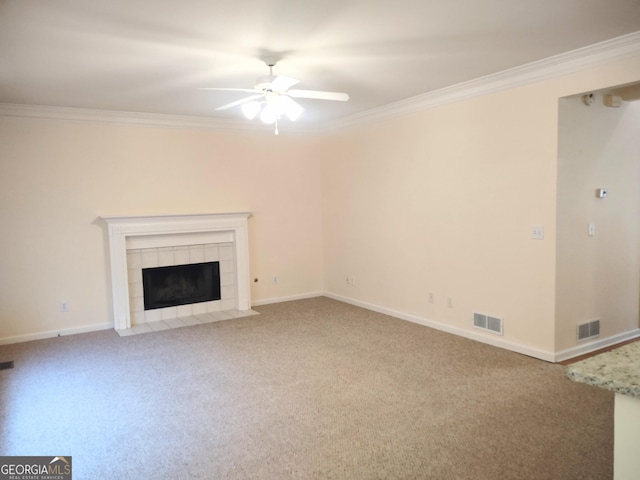 308 Bell Isle, Mcdonough, GA 30252 - unfurnished living room with a ceiling fan, crown molding, carpet floors, a tile fireplace, and baseboards