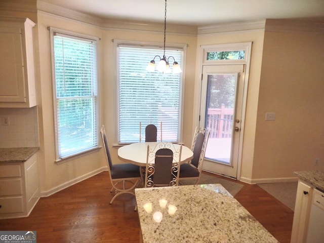 308 Bell Isle, Mcdonough, GA 30252 - dining room with a chandelier, dark wood-type flooring, baseboards, and crown molding