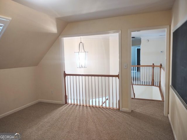 308 Bell Isle, Mcdonough, GA 30252 - additional living space with carpet floors, lofted ceiling, baseboards, and a chandelier