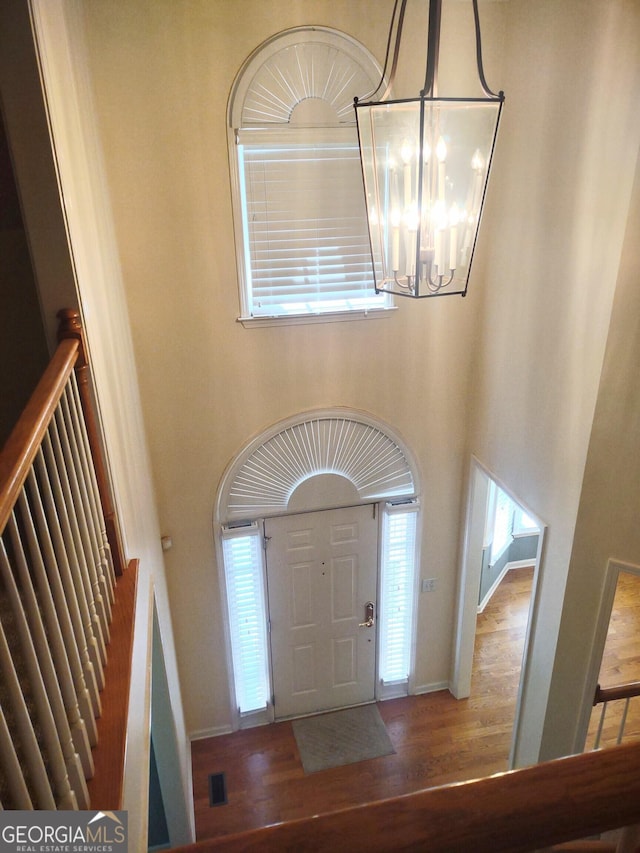 308 Bell Isle, Mcdonough, GA 30252 - entryway with a high ceiling, a chandelier, wood finished floors, stairway, and healthy amount of natural light