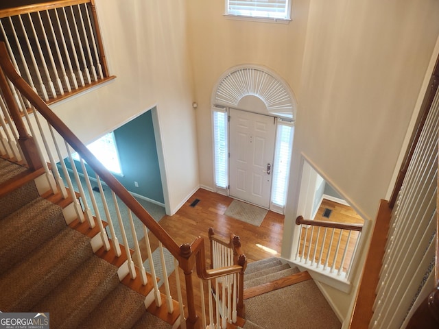 308 Bell Isle, Mcdonough, GA 30252 - entryway with stairway, a towering ceiling, wood finished floors, and baseboards