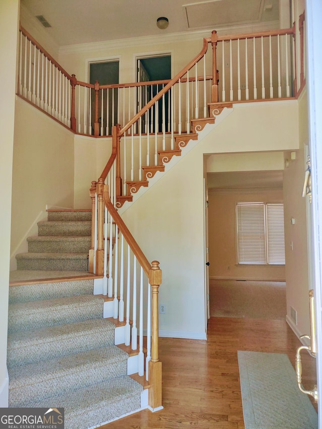 308 Bell Isle, Mcdonough, GA 30252 - stairway featuring wood finished floors, ornamental molding, baseboards, and a high ceiling