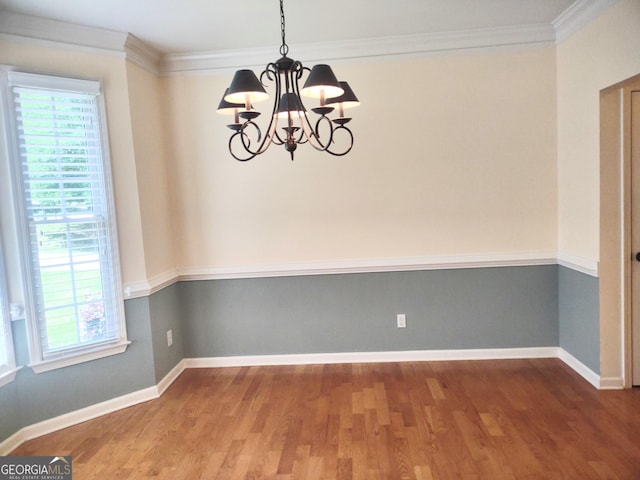 308 Bell Isle, Mcdonough, GA 30252 - spare room featuring a chandelier, wood finished floors, crown molding, and baseboards