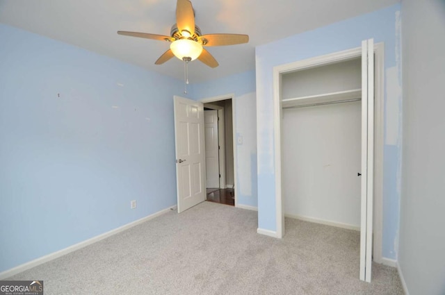 unfurnished bedroom featuring carpet, baseboards, a closet, and ceiling fan