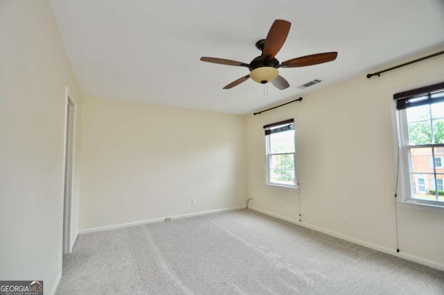 empty room with plenty of natural light, ceiling fan, baseboards, and carpet floors