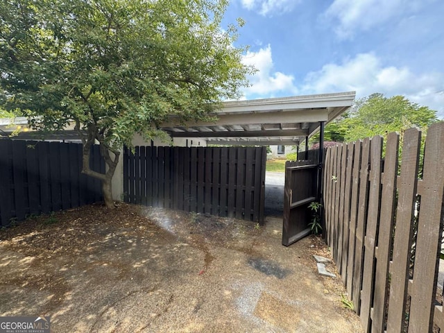 view of vehicle parking with fence