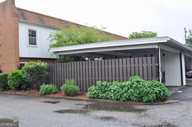 view of home's exterior featuring fence and brick siding