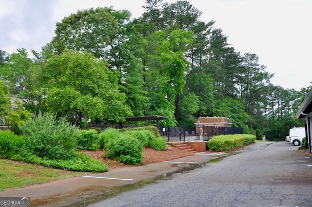 view of home's community featuring fence