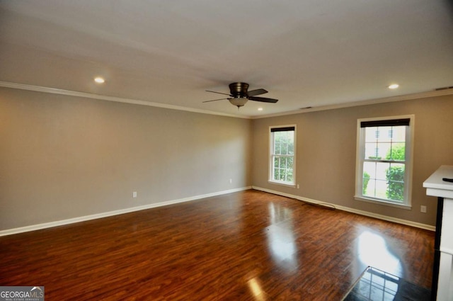 spare room featuring a ceiling fan, crown molding, dark wood-style floors, baseboards, and recessed lighting