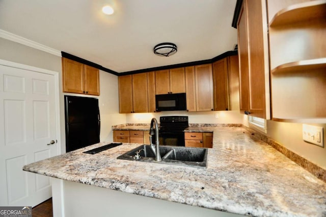kitchen featuring black appliances, a sink, a peninsula, brown cabinetry, and light stone counters