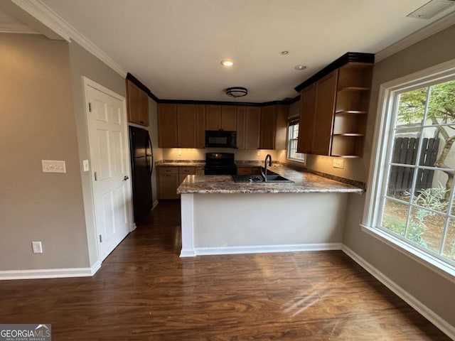 kitchen with black appliances, dark wood-type flooring, open shelves, a peninsula, and ornamental molding