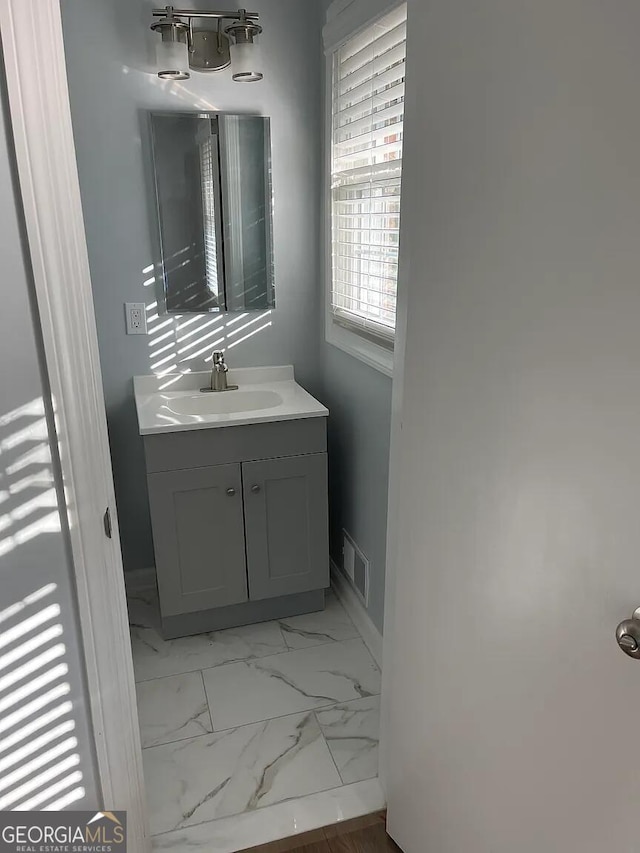 1858 Sahara Dr SE, Atlanta, GA 30316 - bathroom with baseboards, vanity, and marble finish flooring