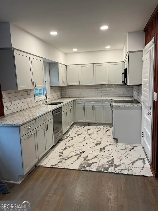 1858 Sahara Dr SE, Atlanta, GA 30316 - kitchen with dishwashing machine, stainless steel microwave, backsplash, a sink, and light stone countertops