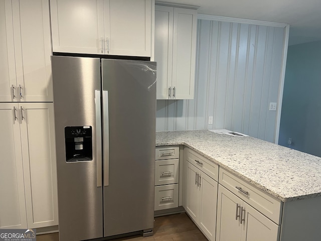 1858 Sahara Dr SE, Atlanta, GA 30316 - kitchen with stainless steel fridge with ice dispenser, a peninsula, light stone counters, and dark wood-style flooring
