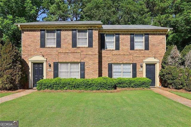 373 Dixie Ct, Lawrenceville, GA 30046 - colonial-style house with a front yard and brick siding