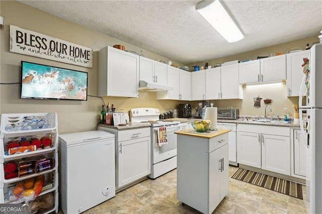 373 Dixie Ct, Lawrenceville, GA 30046 - kitchen with white appliances, under cabinet range hood, a textured ceiling, a center island, and light countertops