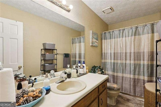 373 Dixie Ct, Lawrenceville, GA 30046 - bathroom with a textured ceiling, vanity, toilet, and a shower with shower curtain