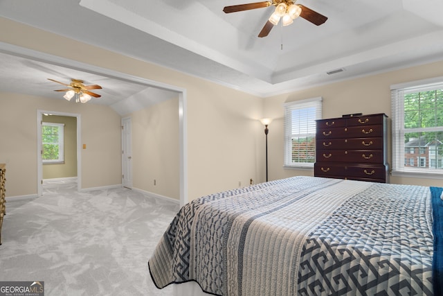 carpeted bedroom featuring multiple windows and baseboards