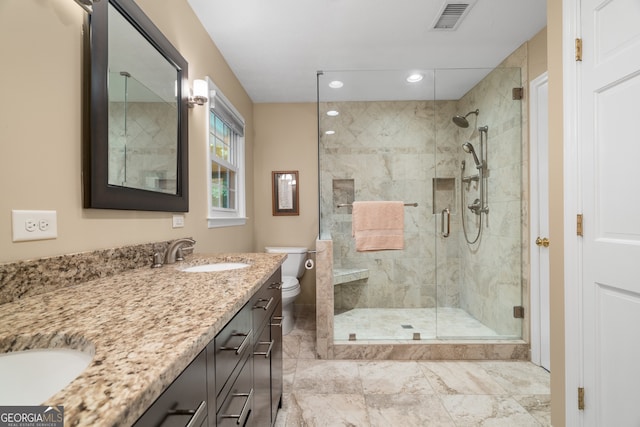 bathroom with a shower stall, toilet, double vanity, recessed lighting, and marble finish floors