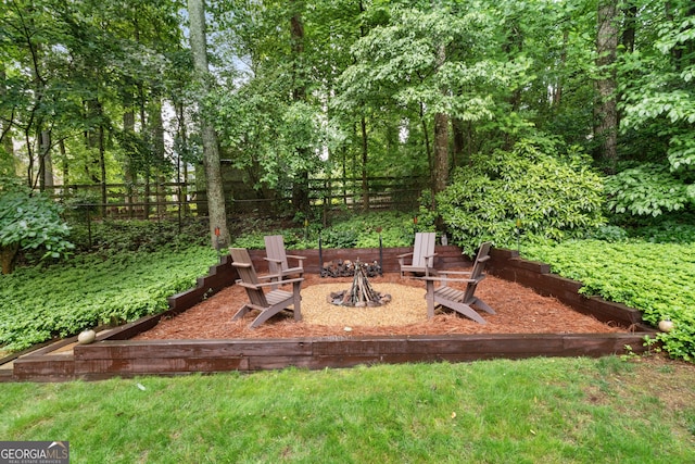 view of patio / terrace featuring fence and a fire pit