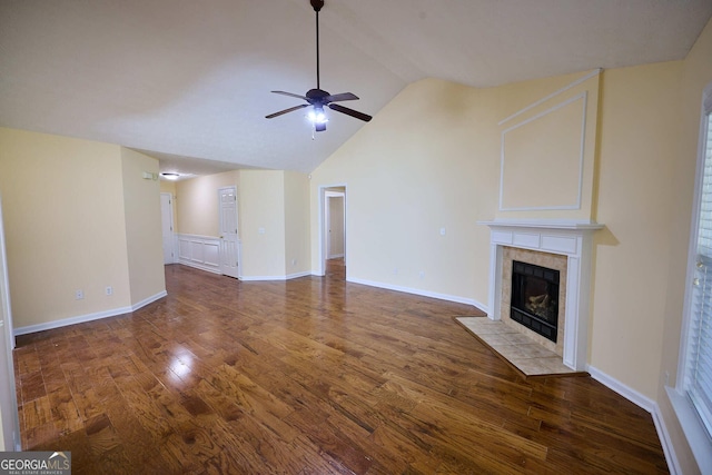 3350 Cooper Woods Dr, Loganville, GA 30052 - unfurnished living room with a ceiling fan, wood finished floors, a tile fireplace, lofted ceiling, and baseboards