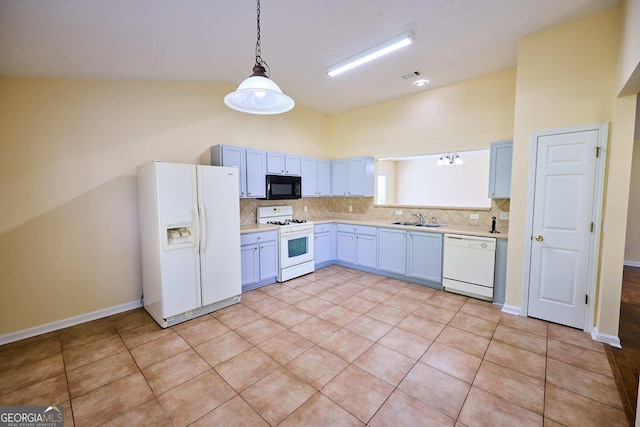 3350 Cooper Woods Dr, Loganville, GA 30052 - kitchen featuring white appliances, a sink, light countertops, backsplash, and lofted ceiling