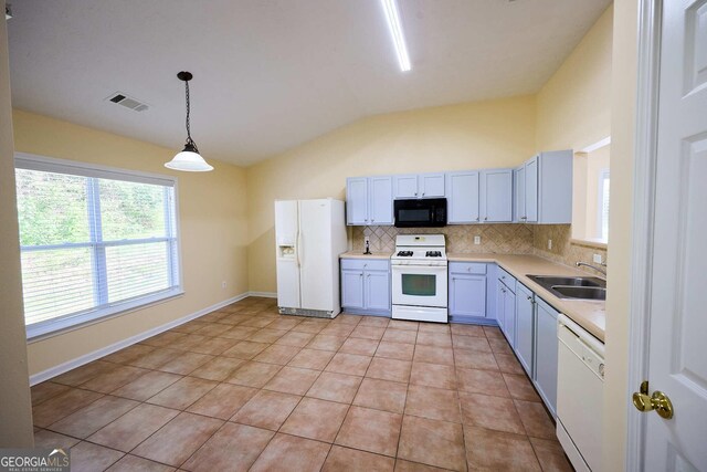 3350 Cooper Woods Dr, Loganville, GA 30052 - kitchen featuring white appliances, a sink, vaulted ceiling, tasteful backsplash, and light countertops