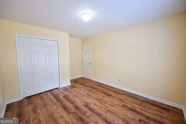 3350 Cooper Woods Dr, Loganville, GA 30052 - unfurnished bedroom with wood finished floors, baseboards, and a closet