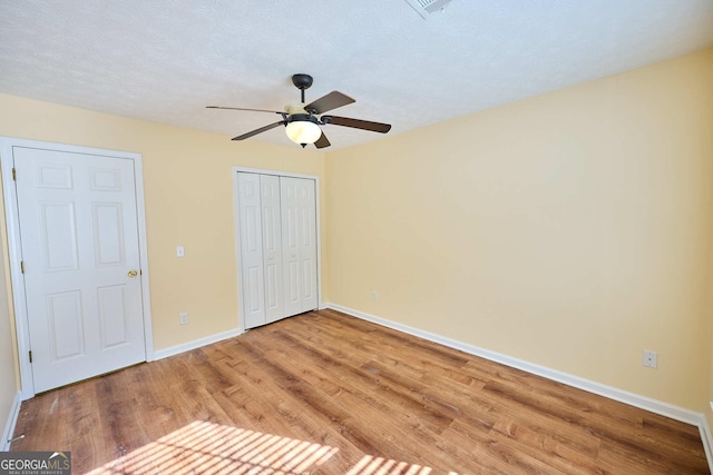3350 Cooper Woods Dr, Loganville, GA 30052 - unfurnished bedroom with wood finished floors, baseboards, a closet, and ceiling fan