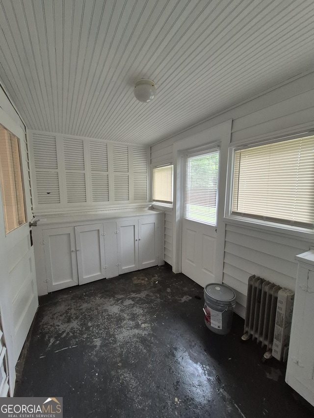 unfurnished sunroom featuring radiator