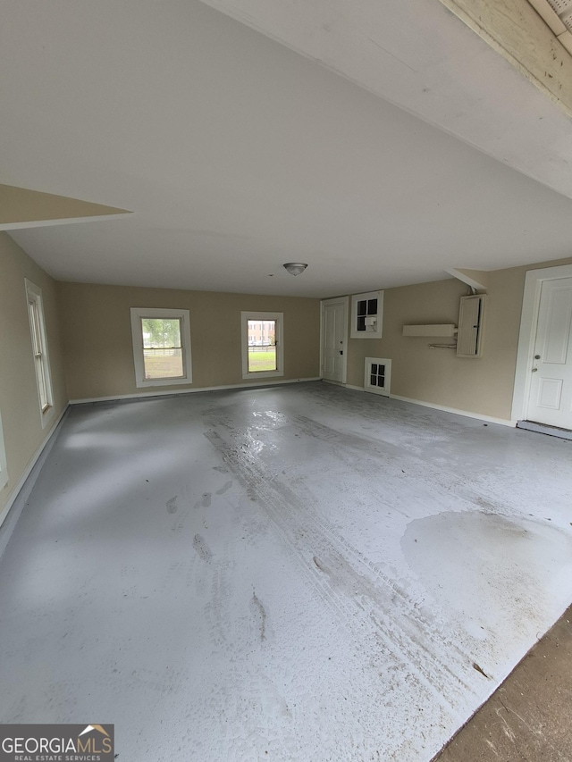 unfurnished living room featuring baseboards