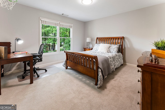 carpeted bedroom with baseboards and an office area