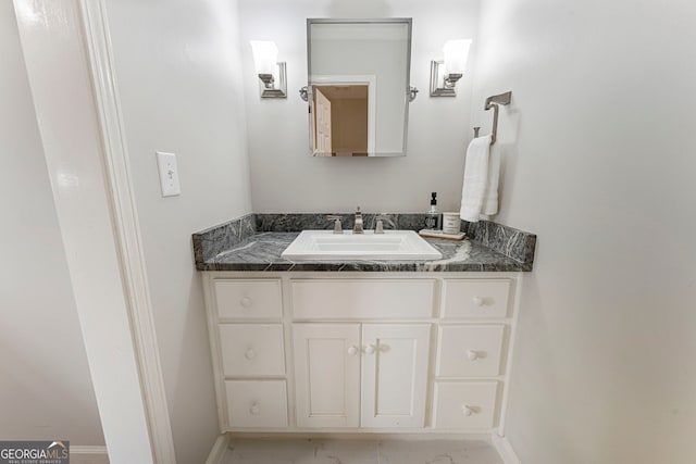 bathroom featuring vanity, marble look tiles, and baseboards