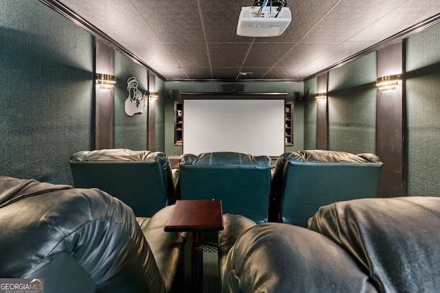 home theater featuring crown molding and a textured wall