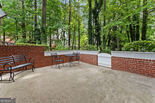 view of patio with a gate and fence