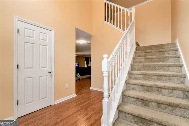 3265 Watson Gate Rd, Loganville, GA 30052 - stairs with wood finished floors and a towering ceiling