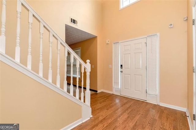 3265 Watson Gate Rd, Loganville, GA 30052 - entryway with a towering ceiling, stairway, and wood finished floors