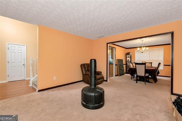 3265 Watson Gate Rd, Loganville, GA 30052 - sitting room featuring light carpet, a chandelier, baseboards, and a textured ceiling