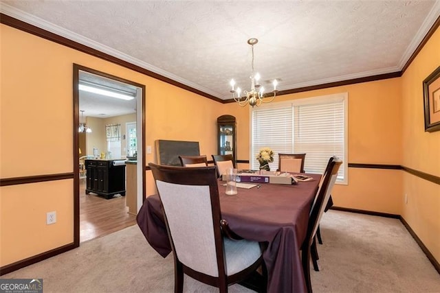 3265 Watson Gate Rd, Loganville, GA 30052 - dining area with a chandelier, light carpet, baseboards, and ornamental molding