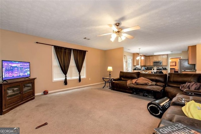 3265 Watson Gate Rd, Loganville, GA 30052 - living area featuring baseboards, ceiling fan, light colored carpet, and a textured ceiling